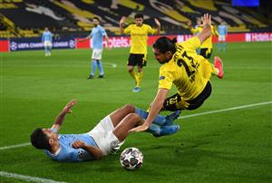 DORTMUND, GERMANY - APRIL 14: Rodrigo of Manchester City battles for possession with Emre Can of Borussia Dortmund during the UEFA Champions League Quarter Final Second Leg match between Borussia Dortmund and Manchester City at Signal Iduna Park on April 14, 2021 in Dortmund, Germany. Sporting stadiums around Germany remain under strict restrictions due to the Coronavirus Pandemic as Government social distancing laws prohibit fans inside venues resulting in games being played behind closed doors. (Photo by Frederic Scheidemann/Getty Images)