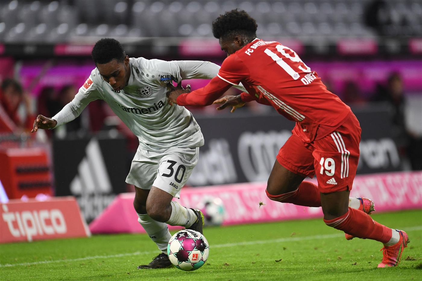 Leverkusen's Dutch defender Jeremie Frimpong (L) and Bayern Munich's Canadian midfielder Alphonso Davies vie for the ball during the German first division Bundesliga football match FC Bayern Munich vs Bayer 04 Leverkusen in Munich, southern Germany, on April 20, 2021.  (Getty Images)