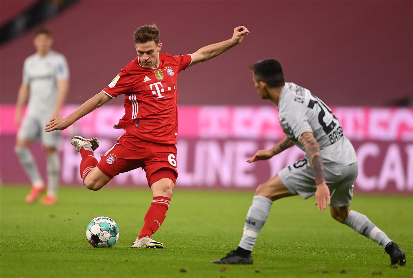 MUNICH, GERMANY - APRIL 20: Joshua Kimmich of FC Bayern Muenchen  is put under pressure by Charles Aranguiz of Bayer Leverkusen  during the Bundesliga match between FC Bayern Muenchen and Bayer 04 Leverkusen at Allianz Arena on April 20, 2021 in Munich, Germany.  (Getty Images)