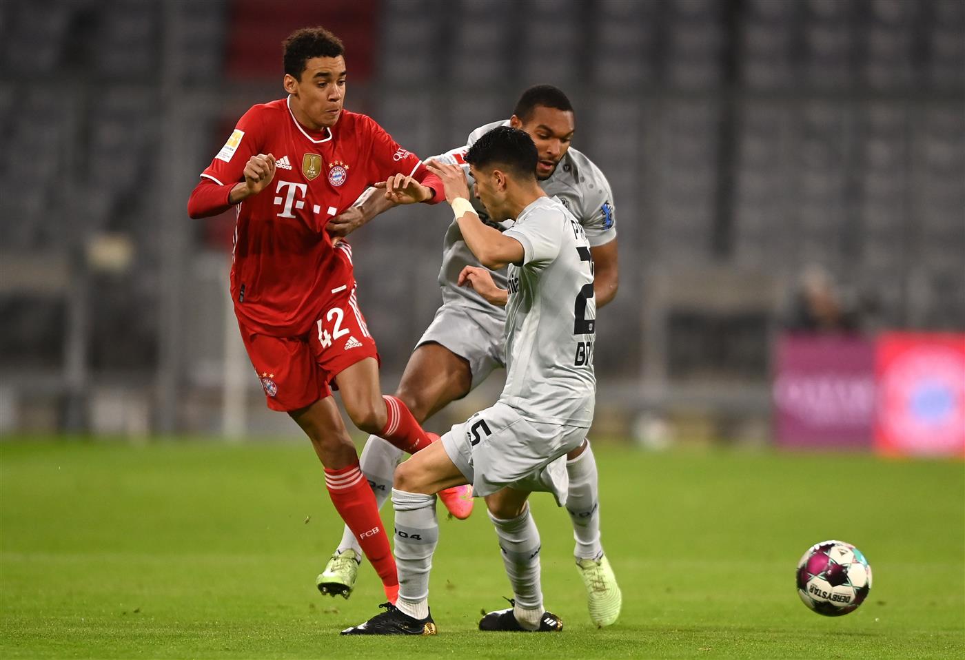 MUNICH, GERMANY - APRIL 20: Jamal Musiala of FC Bayern Muenchen and Exequiel Palacios of Bayer Leverkusen  battle for the ball  during the Bundesliga match between FC Bayern Muenchen and Bayer 04 Leverkusen at Allianz Arena on April 20, 2021 in Munich, Germany.  (Getty Images)
