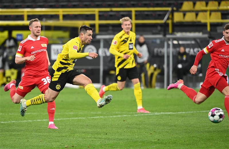 Dortmund's Portuguese defender Raphael Guerreiro scores the 2-0 goal during the German first division Bundesliga football match Borussia Dortmund vs 1. FC Union, in Dortmund, western Germany, on April 21, 2021. (Getty Images)