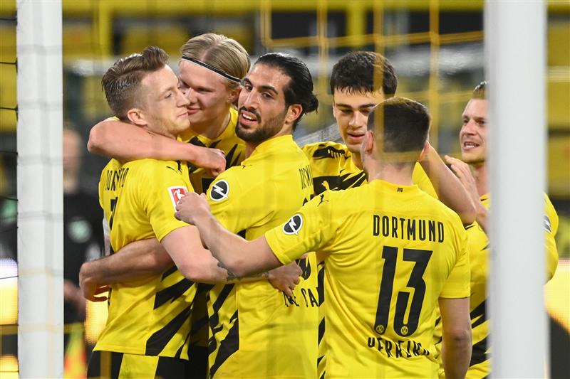 Dortmund's German forward Marco Reus (L) celebrates scoring the opening goal with his teammates during the German first division Bundesliga football match Borussia Dortmund vs 1. FC Union, in Dortmund, western Germany, on April 21, 2021. (Getty Images)