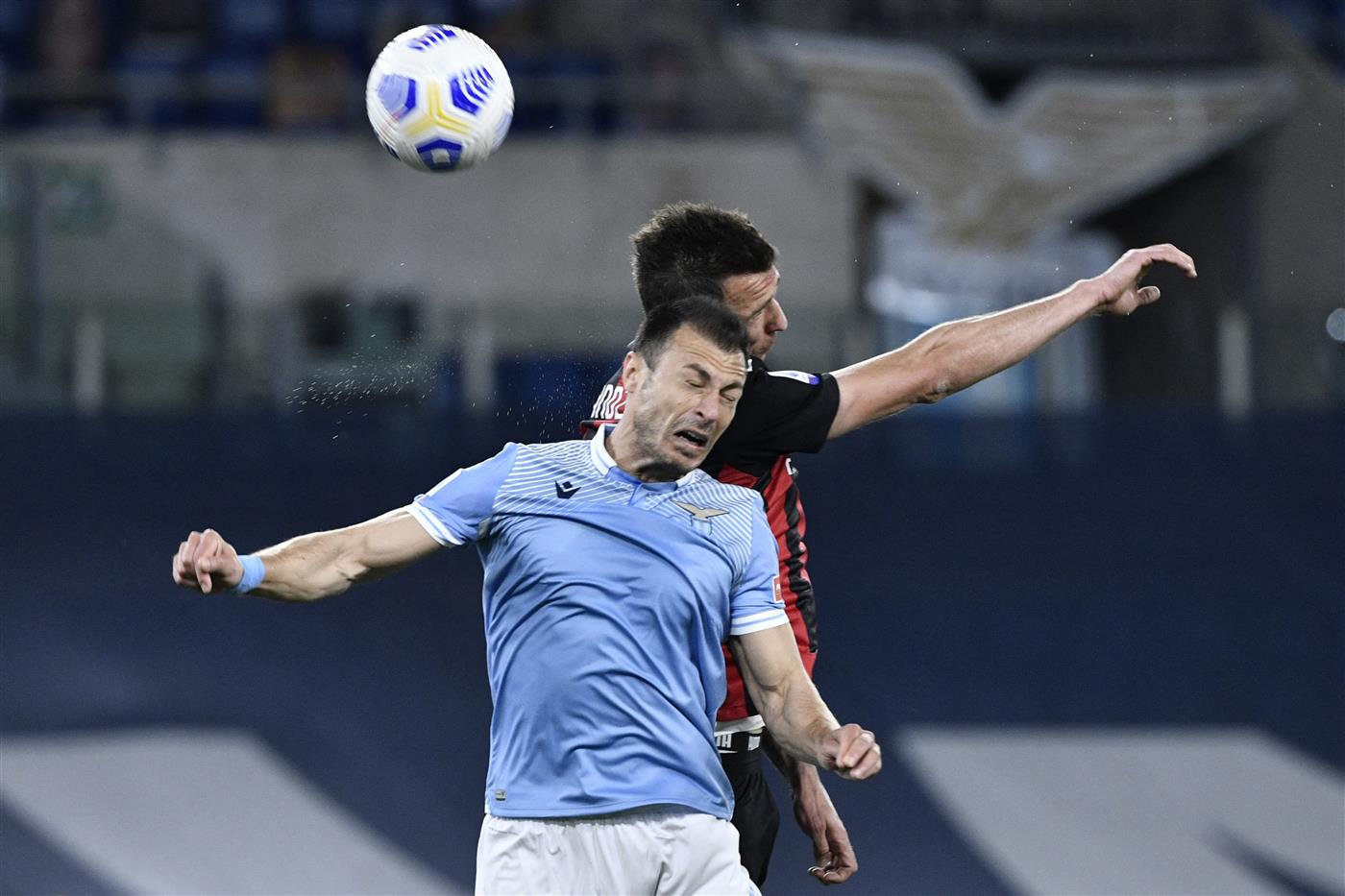 Lazio's Romanian defender Stefan Radu (L) vies with AC Milan's Croatian forward Mario Mandzukic during the Italian Serie A football match Lazio vs Ac Milan at Olympic stadium in Rome on April 26, 2021. (Getty Images)