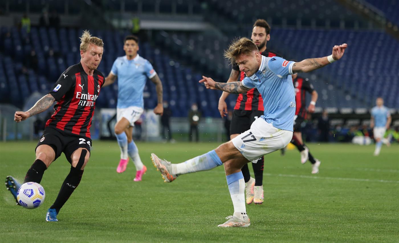 ROME, ITALY - APRIL 26: Ciro Immobile of SS Lazio takes a shot past Simon Kjaer of A.C. Milan  during the Serie A match between SS Lazio and AC Milan at Stadio Olimpico on April 26, 2021 in Rome, Italy. (Getty Images)