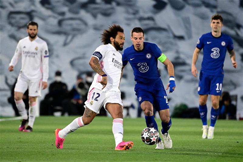 Real Madrid's Brazilian defender Marcelo (2L) challenges Chelsea's Spanish defender Cesar Azpilicueta during the UEFA Champions League semi-final first leg football match between Real Madrid and Chelsea at the Alfredo di Stefano stadium in Valdebebas, on the outskirts of Madrid, on April 27, 2021. (Getty Images)