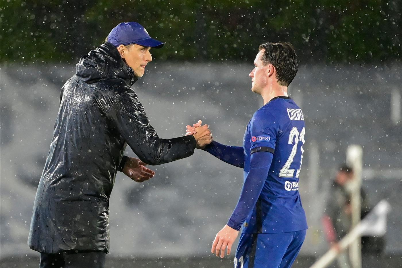 Chelsea's German coach Thomas Tuchel (L) shakes hands with Chelsea's English defender Benjamin Chilwell during the UEFA Champions League semi-final first leg football match between Real Madrid and Chelsea at the Alfredo di Stefano stadium in Valdebebas, on the outskirts of Madrid, on April 27, 2021. (Getty Images)