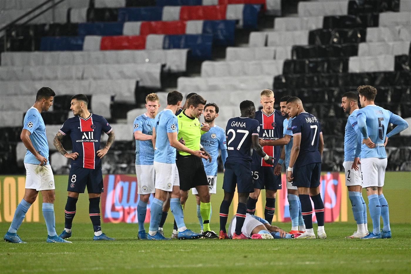 Paris Saint-Germain's Senegalese midfielder Idrissa Gueye talks with Manchester City's Algerian midfielder Riyad Mahrez afrter fouling Manchester City's German midfielder Ilkay Gundogan during the UEFA Champions League first leg semi-final football match between Paris Saint-Germain (PSG) and Manchester City at the Parc des Princes stadium in Paris on April 28, 2021.  (Getty Images)