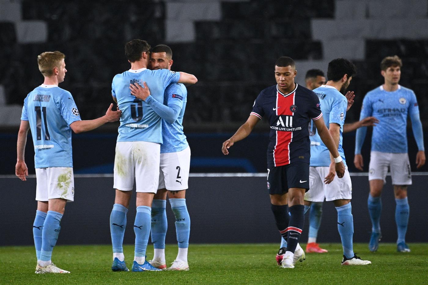 Paris Saint-Germain's French forward Kylian Mbappe reacts as Manchester City players celebrate after winning the UEFA Champions League first leg semi-final football match between Paris Saint-Germain (PSG) and Manchester City at the Parc des Princes stadium in Paris on April 28, 2021. (Getty Images)
