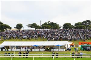WARRNAMBOOL, AUSTRALIA - MAY 06: Racegoers on the hill watch Race 7, the Grand Annual Steeplechase, on Grand Annual Day during the Warrnambool Jumps Carnival at Warrnambool Racing Club on May 06, 2021 in Warrnambool, Australia. (Photo by Vince Caligiuri/Getty Images)