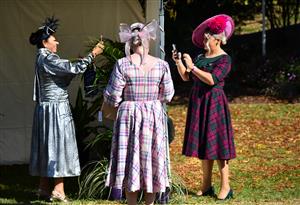 WARRNAMBOOL, AUSTRALIA - MAY 06: Racegoers using the QR code to check in to fashions on the field on Grand Annual Day during the Warrnambool Jumps Carnival at Warrnambool Racing Club on May 06, 2021 in Warrnambool, Australia. (Photo by Vince Caligiuri/Getty Images)