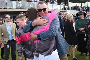 WARRNAMBOOL, AUSTRALIA - MAY 06: Clayton Douglas hugs trainer Symon Wilde after riding Gold Medals to win Race 7, the Grand Annual Steeplechase, on Grand Annual Day during the Warrnambool Jumps Carnival at Warrnambool Racing Club on May 06, 2021 in Warrnambool, Australia. (Photo by Vince Caligiuri/Getty Images)