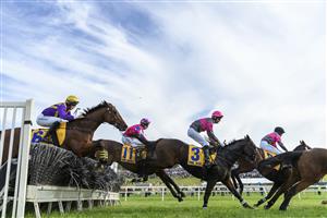WARRNAMBOOL, AUSTRALIA - MAY 06: Clayton Douglas riding Gold Medals ( #3) jumping in the first lap before defeating Aaron Kuru riding Zed Em in Race 7, the Grand Annual Steeplechase, on Grand Annual Day during the Warrnambool Jumps Carnival at Warrnambool Racing Club on May 06, 2021 in Warrnambool, Australia. (Photo by Vince Caligiuri/Getty Images)