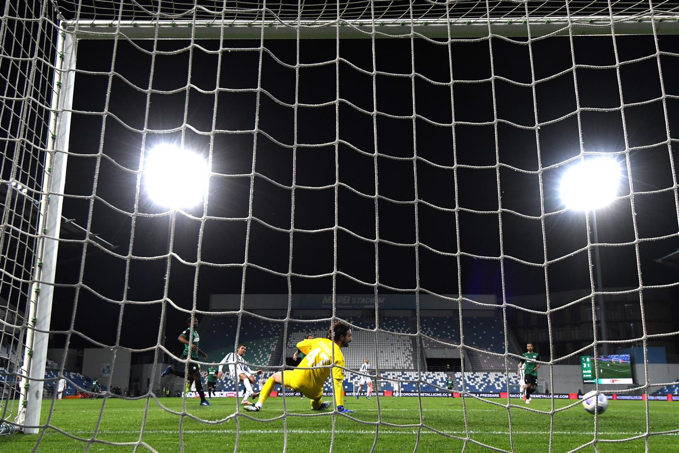 REGGIO NELL'EMILIA, ITALY - MAY 12: Cristiano Ronaldo of Juventus scores their side's second goal past Andrea Consigli of U.S. Sassuolo Calcio during the Serie A match between US Sassuolo and Juventus at Mapei Stadium - Città del Tricolore on May 12, 2021 in Reggio nell'Emilia, Italy. Sporting stadiums around Italy remain under strict restrictions due to the Coronavirus Pandemic as Government social distancing laws prohibit fans inside venues resulting in games being played behind closed doors.  (Getty Images)