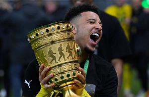 Dortmund's English midfielder Jadon Sancho holds the trophy after the ceremony after the German Cup (DFB Pokal) final football match RB Leipzig v BVB Borussia Dortmund, in Berlin on May 13, 2021. (Getty Images)