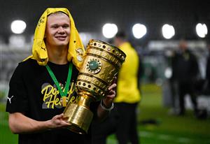 Dortmund's Norwegian forward Erling Braut Haaland poses with the trophy after the German Cup (DFB Pokal) final football match RB Leipzig v BVB Borussia Dortmund, in Berlin on May 13, 2021. (Getty Images)