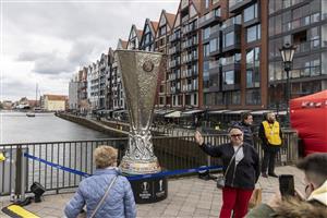 GDANSK, POLAND - MAY 26: Visitors pose next to replica trophy that is displayed at the Green Bridge (Zielony Most) in Old Town prior the UEFA Europa League Final between Villarreal CF and Manchester United on May 26, 2021 in Gdansk, Poland. (Getty Images)