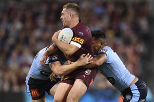 TOWNSVILLE, AUSTRALIA - JUNE 09: Cameron Munster of the Maroons is tackled during game one of the 2021 State of Origin series between the New South Wales Blues and the Queensland Maroons at Queensland Country Bank Stadium on June 09, 2021 in Townsville, Australia. (Photo by Ian Hitchcock/Getty Images)