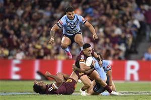 TOWNSVILLE, AUSTRALIA - JUNE 09: Valentine Holmes of the Maroons is tackled during game one of the 2021 State of Origin series between the New South Wales Blues and the Queensland Maroons at Queensland Country Bank Stadium on June 09, 2021 in Townsville, Australia. (Photo by Ian Hitchcock/Getty Images)
