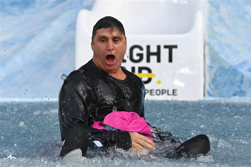 MELBOURNE, AUSTRALIA - JUNE 14: Shane Crawford goes down the slide during the Big Freeze slide at Melbourne Cricket Ground on June 14, 2021 in Melbourne, Australia. The annual event aims to raise funds to fight MND as part of the Queen's Birthday AFL match, this year held at the SCG due to Covid19 protocols in Melbourne preventing crowd from attending this year's event. (Photo by Quinn Rooney/Getty Images)