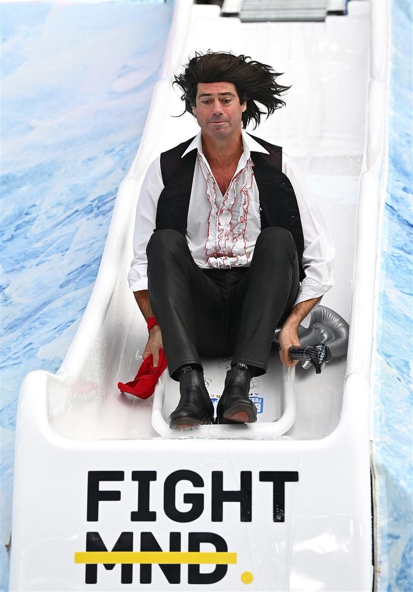 MELBOURNE, AUSTRALIA - JUNE 14: Gil McLachlan the AFL CEO goes down the slide during the Big Freeze slide at Melbourne Cricket Ground on June 14, 2021 in Melbourne, Australia. The annual event aims to raise funds to fight MND as part of the Queen's Birthday AFL match, this year held at the SCG due to Covid19 protocols in Melbourne preventing crowd from attending this year's event. (Photo by Quinn Rooney/Getty Images)