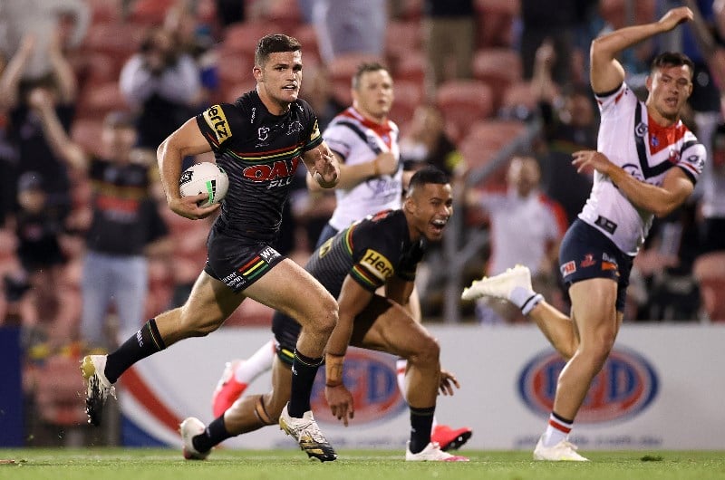 Billy Smith of the Roosters is tackled by Mitch Kenny (left) and