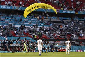 MUNICH, GERMANY - JUNE 15: A greenpeace protester and pitch invader is removed from the pitch by stewards after flying into the stadium prior to the UEFA Euro 2020 Championship Group F match between France and Germany at Football Arena Munich on June 15, 2021 in Munich, Germany. (Getty Images)