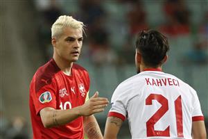 Switzerland's midfielder Granit Xhaka (L) shakes hands with Turkey's midfielder Irfan Can Kahveci during the UEFA EURO 2020 Group A football match between Switzerland and Turkey at the Olympic Stadium in Baku on June 20, 2021. (Getty Images)