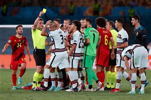 TOPSHOT - German referee Felix Brych presents a yellow card to Portugal's defender Pepe (3L) during the UEFA EURO 2020 round of 16 football match between Belgium and Portugal at La Cartuja Stadium in Seville on June 27, 2021. (Getty Images)
