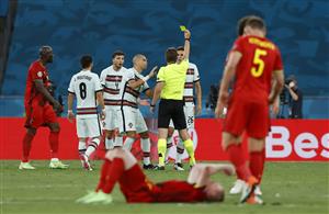 SEVILLE, SPAIN - JUNE 27: Joao Palhinha of Portugal is shown a yellow card by Match Referee, Felix Brych as Kevin De Bruyne of Belgium looks to be injured during the UEFA Euro 2020 Championship Round of 16 match between Belgium and Portugal at Estadio La Cartuja on June 27, 2021 in Seville, Spain. (Getty Images)