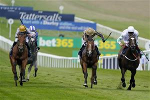 NEWMARKET, ENGLAND - JULY 08: Pat Dobbs riding Lusail (L, gold cap) win The Tattersalls July Stakes at Newmarket Racecourse on July 08, 2021 in Newmarket, England. Due to the Coronavirus pandemic, only owners along with a limited number of the paying public will be allowed to attend the meeting. (Photo by Alan Crowhurst/Getty Images)