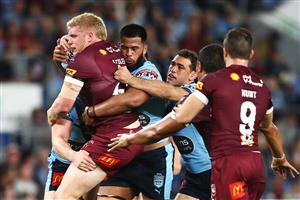 GOLD COAST, AUSTRALIA - JULY 14: Thomas Flegler of the Maroons is tackled during game three of the 2021 State of Origin Series between the New South Wales Blues and the Queensland Maroons at Cbus Super Stadium on July 14, 2021 in Gold Coast, Australia. (Photo by Chris Hyde/Getty Images)