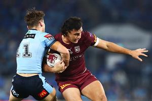 GOLD COAST, AUSTRALIA - JULY 14: Tino Fa'asuamaleaui of the Maroons is tackled during game three of the 2021 State of Origin Series between the New South Wales Blues and the Queensland Maroons at Cbus Super Stadium on July 14, 2021 in Gold Coast, Australia. (Photo by Chris Hyde/Getty Images)