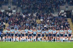GOLD COAST, AUSTRALIA - JULY 14: The Blues stand and sing the national anthem before game three of the 2021 State of Origin Series between the New South Wales Blues and the Queensland Maroons at Cbus Super Stadium on July 14, 2021 in Gold Coast, Australia. (Photo by Bradley Kanaris/Getty Images)