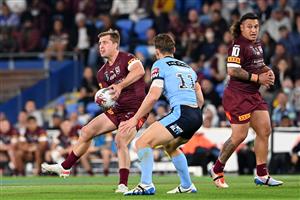 GOLD COAST, AUSTRALIA - JULY 14: Cameron Munster of the Maroons offloads the ball during game three of the 2021 State of Origin Series between the New South Wales Blues and the Queensland Maroons at Cbus Super Stadium on July 14, 2021 in Gold Coast, Australia. (Photo by Bradley Kanaris/Getty Images)