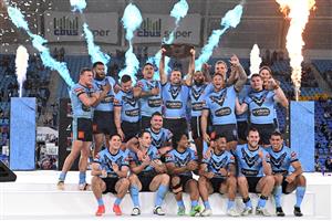 GOLD COAST, AUSTRALIA - JULY 14: James Tedesco of the Blues holds aloft the Origin trophy and celebrates with team mates after winning the series 2-1 after game three of the 2021 State of Origin Series between the New South Wales Blues and the Queensland Maroons at Cbus Super Stadium on July 14, 2021 in Gold Coast, Australia. (Photo by Bradley Kanaris/Getty Images)