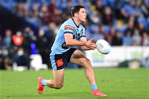GOLD COAST, AUSTRALIA - JULY 14: Mitchell Moses of the Blues offloads the ball during game three of the 2021 State of Origin Series between the New South Wales Blues and the Queensland Maroons at Cbus Super Stadium on July 14, 2021 in Gold Coast, Australia. (Photo by Bradley Kanaris/Getty Images)