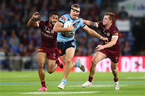 GOLD COAST, AUSTRALIA - JULY 14: Tom Trbojevic of the Blues is tackled by Cameron Munster of the Maroons during game three of the 2021 State of Origin Series between the New South Wales Blues and the Queensland Maroons at Cbus Super Stadium on July 14, 2021 in Gold Coast, Australia. (Photo by Chris Hyde/Getty Images)