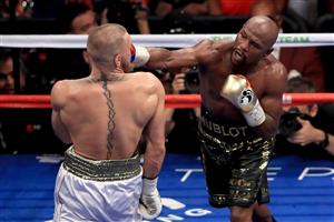 LAS VEGAS, NV - AUGUST 26: (R-L) Floyd Mayweather Jr. throws a punch at Conor McGregor during their super welterweight boxing match on August 26, 2017 at T-Mobile Arena in Las Vegas, Nevada. (Getty Images)