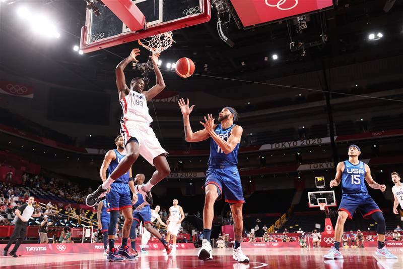 SAITAMA, JAPAN - JULY 25: Moustapha Fall #93 of Team France dunks the ball over JaVale McGee #11 of Team United States during the second half of the Men's Preliminary Round Group B game on day two of the Tokyo 2020 Olympic Games at Saitama Super Arena on July 25, 2021 in Saitama, Japan. (Getty Images)