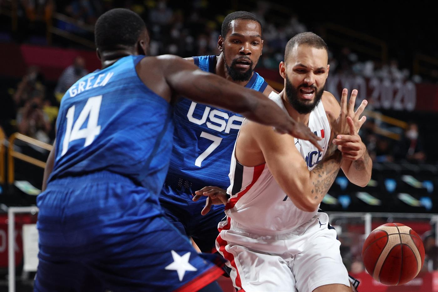 France's Evan Fournier (R) fights for the ball with USA's Draymond Jamal Green (L) during the men's preliminary round group A basketball match between France and USA during the Tokyo 2020 Olympic Games at the Saitama Super Arena in Saitama on July 25, 2021.  (Getty Images)