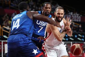 France's Evan Fournier (R) fights for the ball with USA's Draymond Jamal Green (L) during the men's preliminary round group A basketball match between France and USA during the Tokyo 2020 Olympic Games at the Saitama Super Arena in Saitama on July 25, 2021.  (Getty Images)
