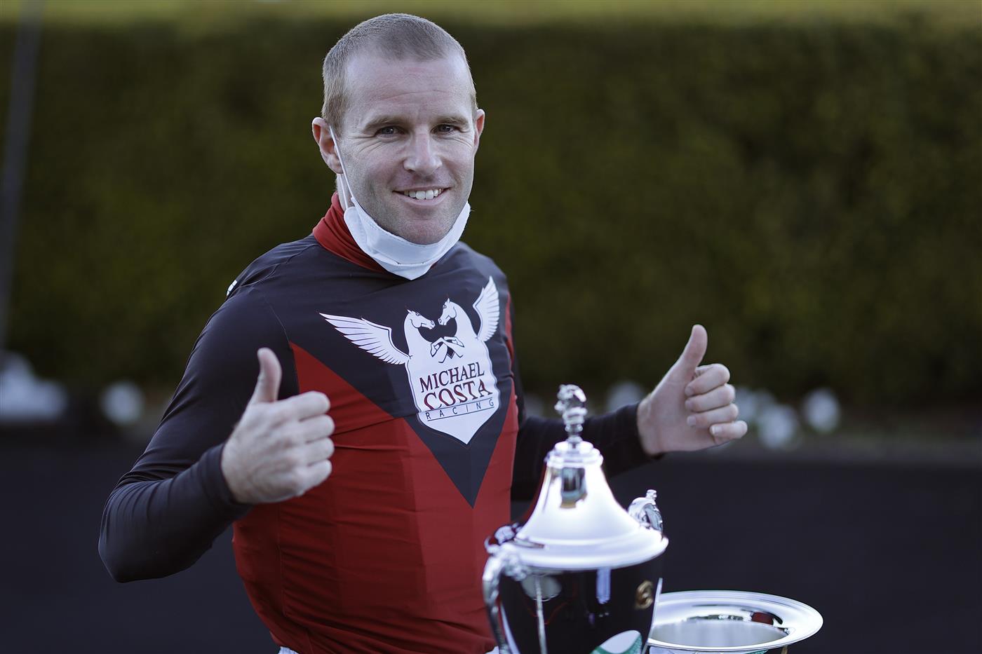 SYDNEY, AUSTRALIA - AUGUST 07: Tommy Berry poses with the trophy after winning race 7 the Heineken Missile Stakes on Phobetor during Sydney Racing at Royal Randwick Racecourse on August 07, 2021 in Sydney, Australia. (Photo by Mark Evans/Getty Images)
