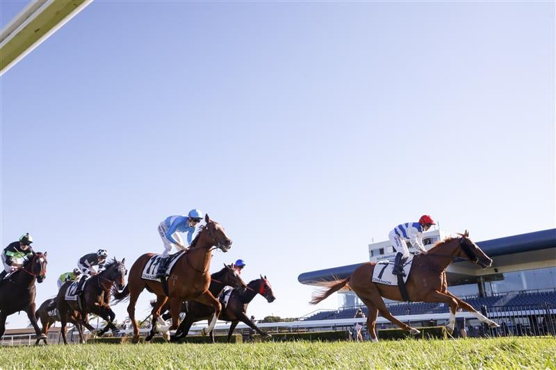 KEMBLA GRANGE, AUSTRALIA - SEPTEMBER 11: Brock Ryan (red cap) on Chat wins race 7 The Chandon Theo Marks Stakes during Sydney Racing at Kembla Grange Racecourse on September 11, 2021 in Kembla Grange, Australia. (Photo by Mark Evans/Getty Images)