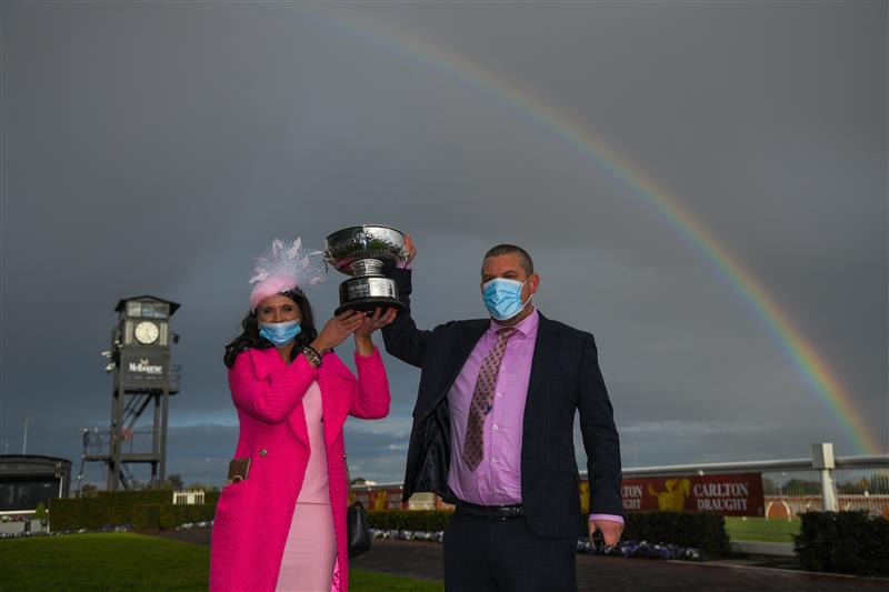 MELBOURNE, AUSTRALIA - SEPTEMBER 18: Trainers Natalie Young and Trent Busuttin pose with the trophy after Sierra Sue won Race 8, the Neds Sir Rupert Clarke Stakes, during Melbourne Racing at Caulfield Racecourse on September 18, 2021 in Melbourne, Australia. (Photo by Vince Caligiuri/Getty Images)