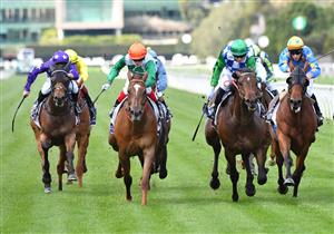 MELBOURNE, AUSTRALIA - SEPTEMBER 22: Craig Williams riding Cuban Link (L) winning Race 3, the Myer Fashions On Your Front Lawn, during Melbourne Racing at Flemington Racecourse on September 22, 2021 in Melbourne, Australia. (Photo by Vince Caligiuri/Getty Images)