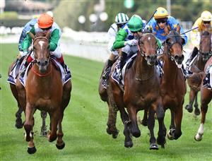 MELBOURNE, AUSTRALIA - SEPTEMBER 22: Craig Williams riding Cuban Link (L) winning Race 3, the Myer Fashions On Your Front Lawn, during Melbourne Racing at Flemington Racecourse on September 22, 2021 in Melbourne, Australia. (Photo by Vince Caligiuri/Getty Images)