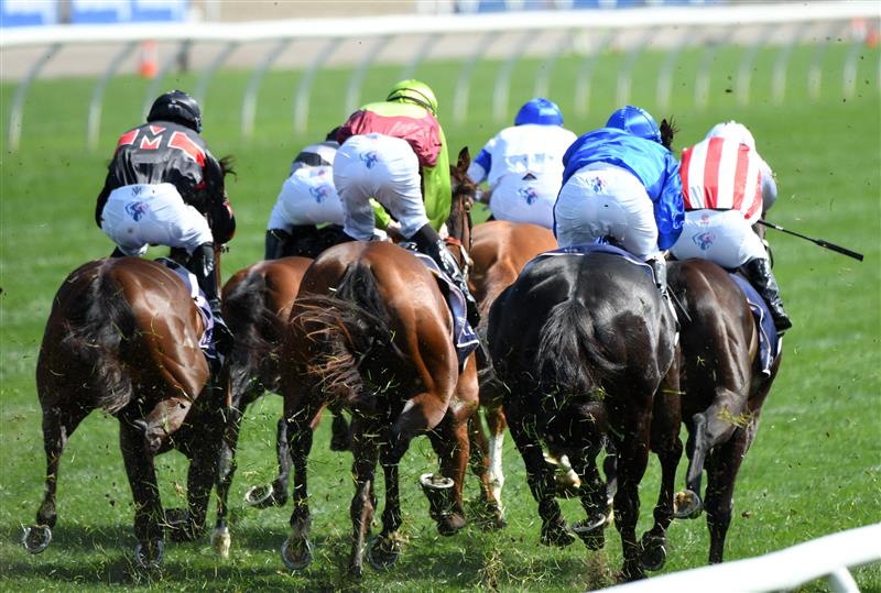 MELBOURNE, AUSTRALIA - OCTOBER 02: Damien Oliver riding Kementari (r) winning Race 4, the Gilgai Stakes during Melbourne Racing at Flemington Racecourse on October 02, 2021 in Melbourne, Australia. (Photo by Vince Caligiuri/Getty Images)