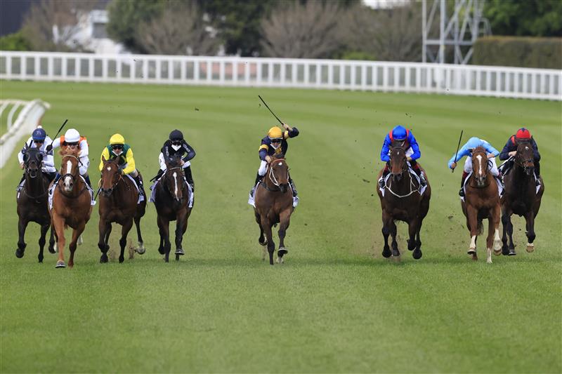 SYDNEY, AUSTRALIA - OCTOBER 02: Tommy Berry on Masked Crusader (yellow cap), wins race 6 the ACY Securities Premiere Stakes during Sydney Racing on Epsom Day at Royal Randwick Racecourse on October 02, 2021 in Sydney, Australia. (Photo by Mark Evans/Getty Images)