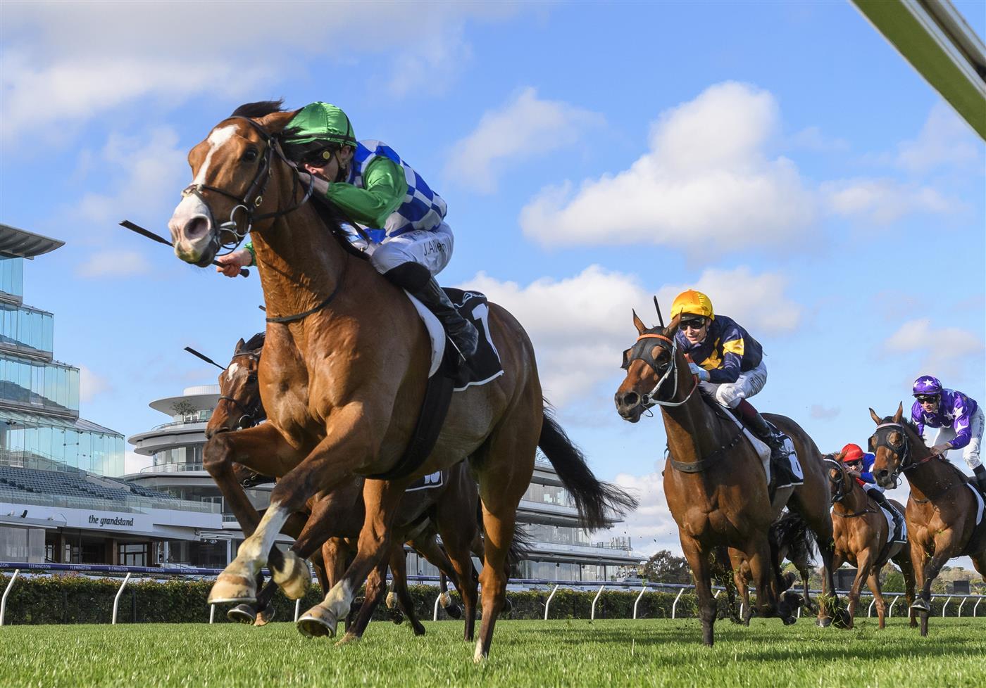 MELBOURNE, AUSTRALIA - OCTOBER 02: John Allen riding Grand Promenade winning  Race 8, the Lexus Bart Cummings,  during Melbourne Racing at Flemington Racecourse on October 02, 2021 in Melbourne, Australia. (Photo by Vince Caligiuri/Getty Images)