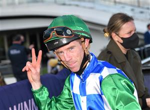 MELBOURNE, AUSTRALIA - OCTOBER 02: John Allen riding Grand Promenade winning Race 8, the Lexus Bart Cummings,  during Melbourne Racing at Flemington Racecourse on October 02, 2021 in Melbourne, Australia. (Photo by Vince Caligiuri/Getty Images)